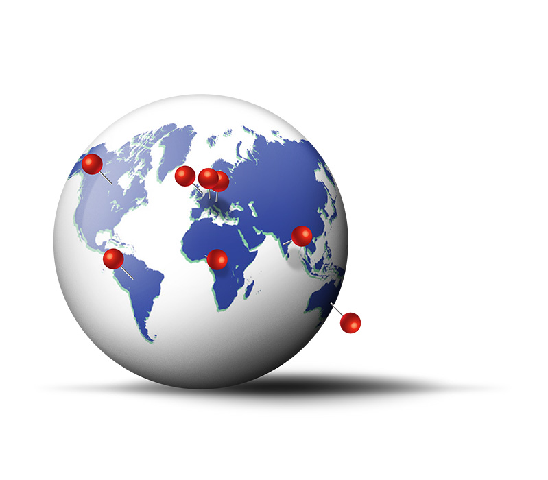 A globe with pin markers on several continents